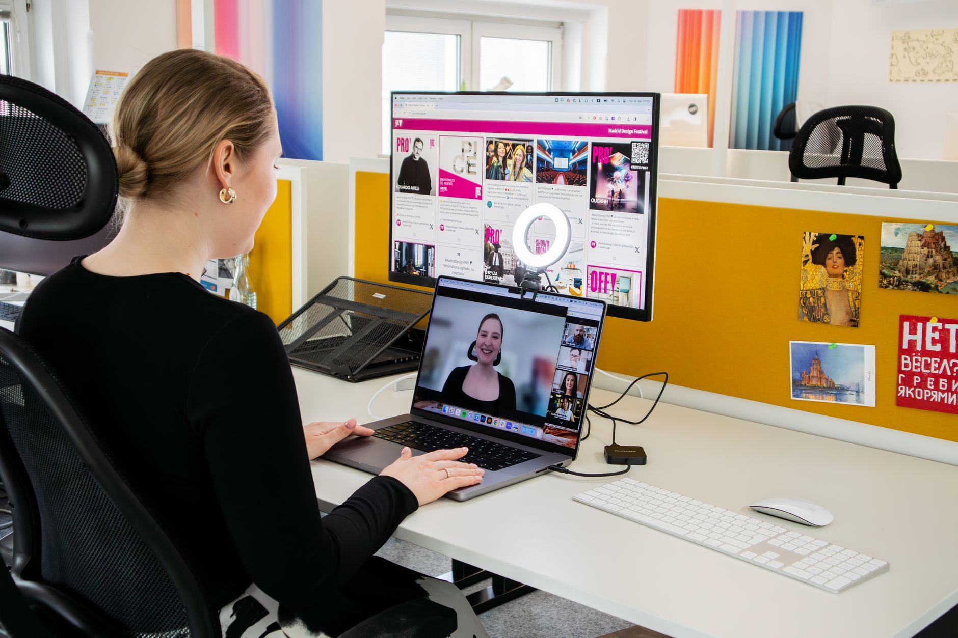 Woman engaged in a video call at her office desk, using technology for remote work and communication.