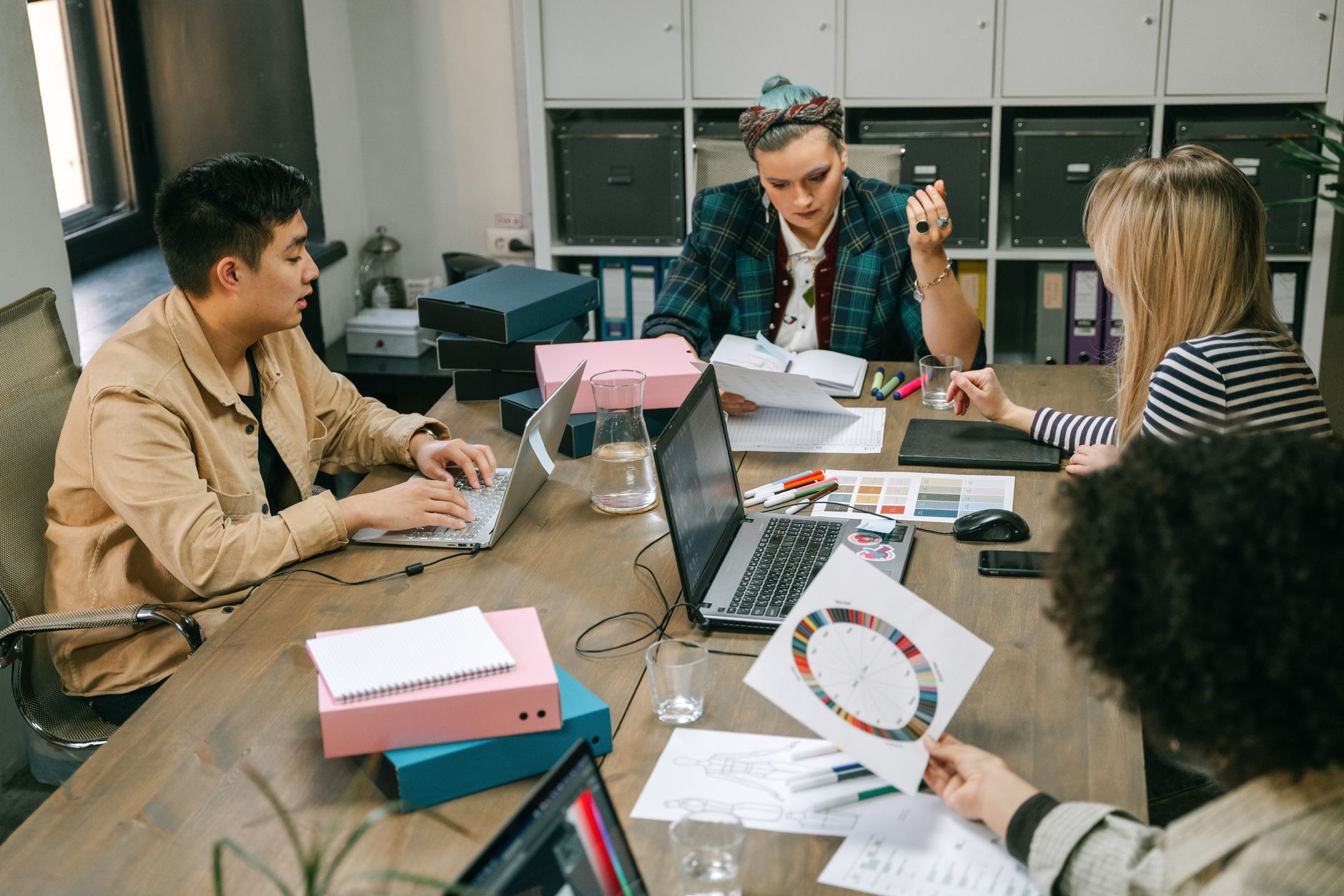 A group of professionals engaged in a planning meeting at the office, showcasing teamwork and collaboration.