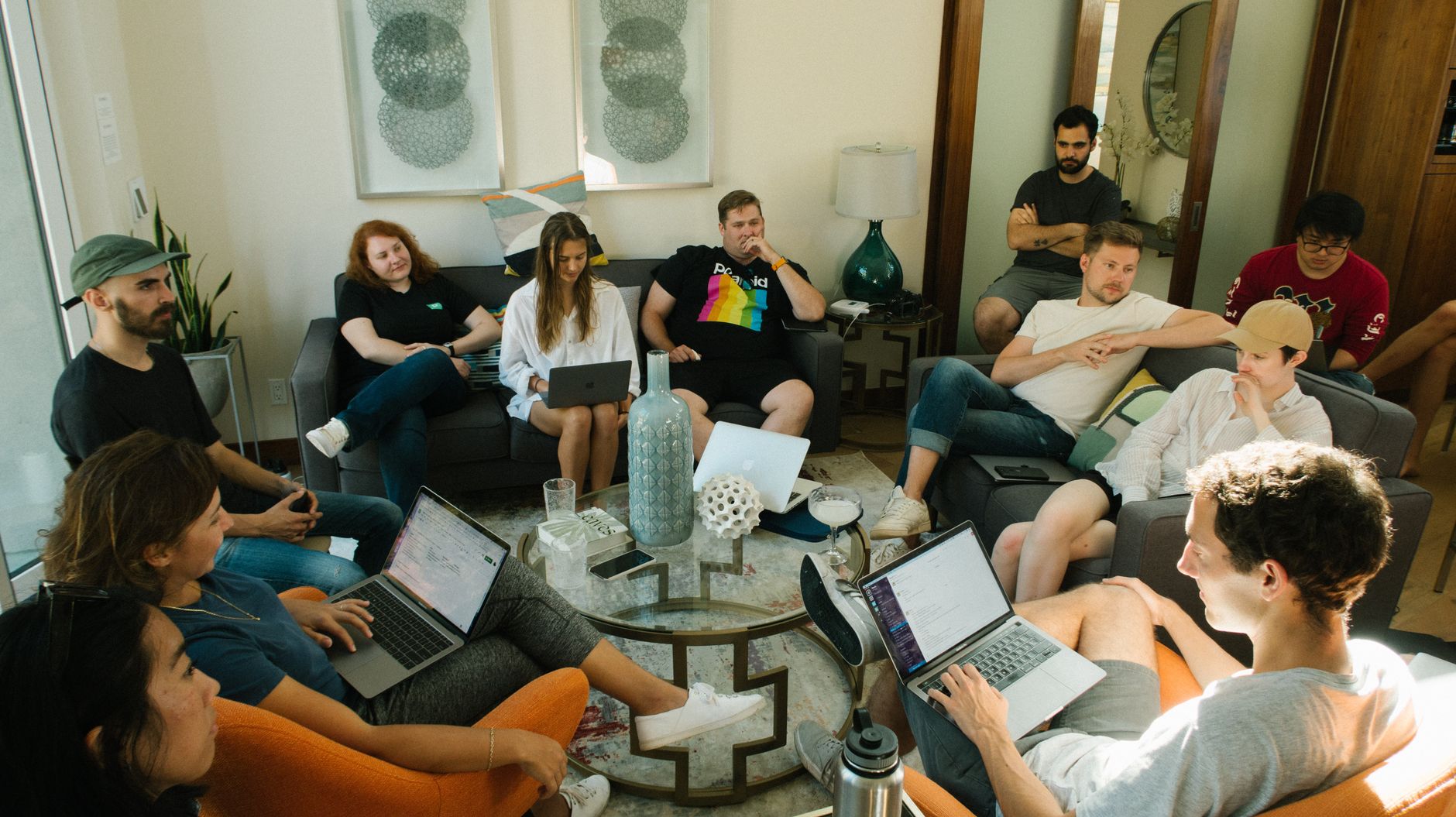 A diverse group of adults collaborating in a relaxed home office environment.